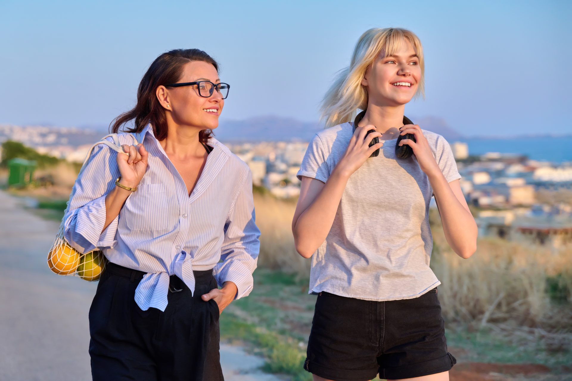 summer-walk-of-smiling-mom-and-teenage-daughter-2022-02-10-20-43-34-utc