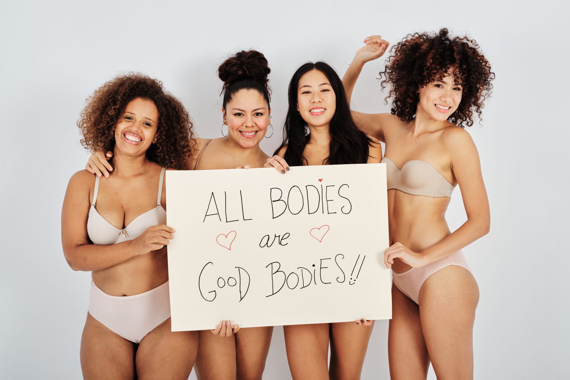 happy-multiracial-women-with-motivational-banner-2023-11-27-05-11-16-utc