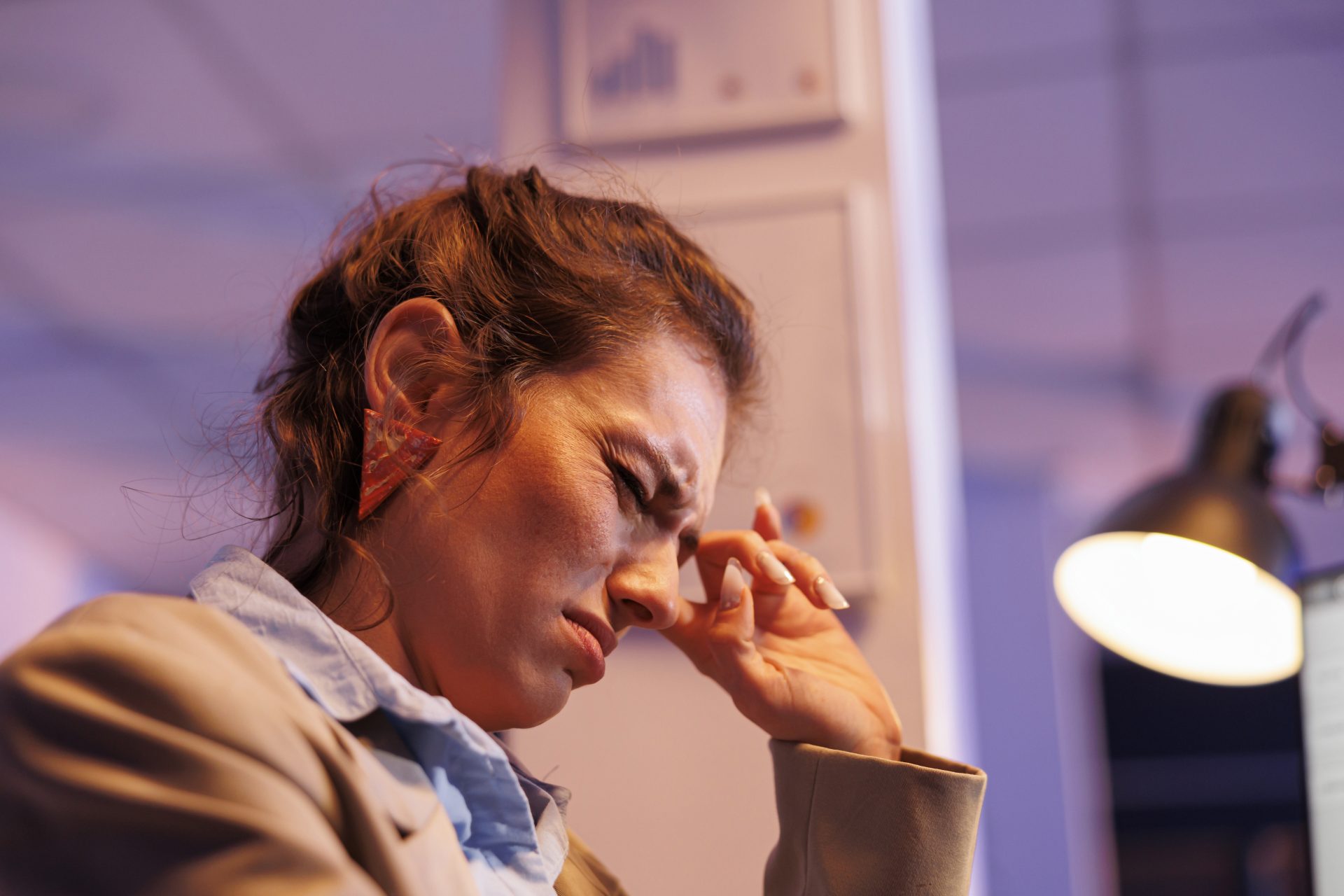 exhausted-businesswoman-working-overhours-at-finan-2024-02-07-15-26-11-utc