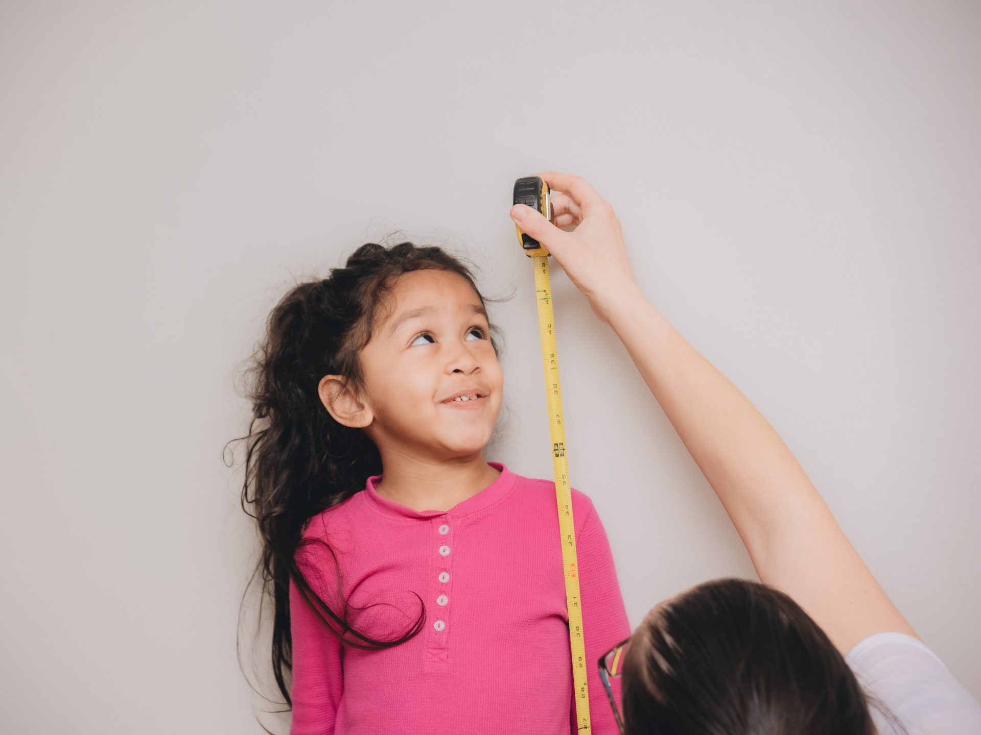 mother-and-diverse-daughter-at-home-using-tape-mea-2024-11-01-02-33-30-utc