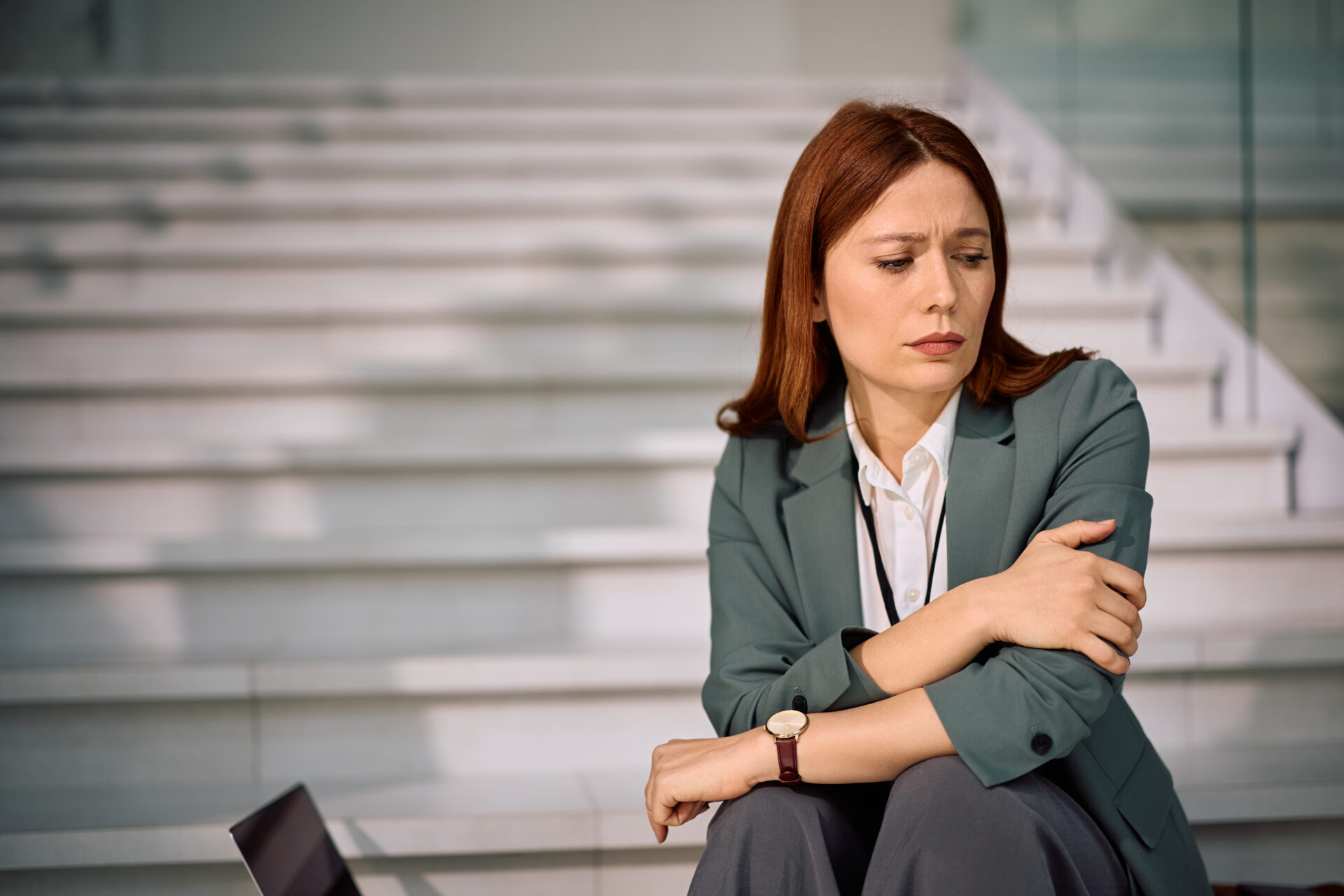 Sad entrepreneur thinking of her problems at work.