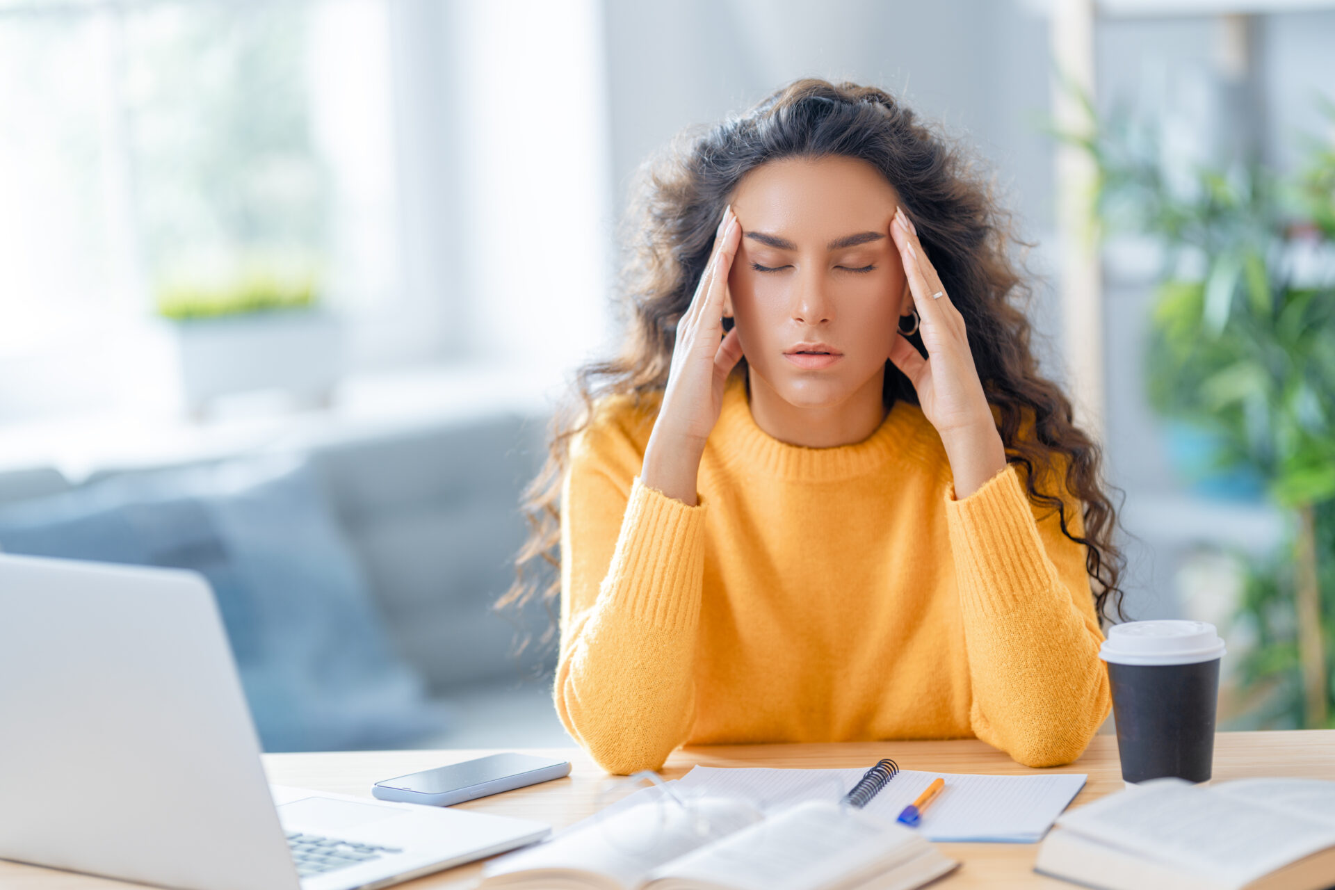 Young woman studying and having a head ache